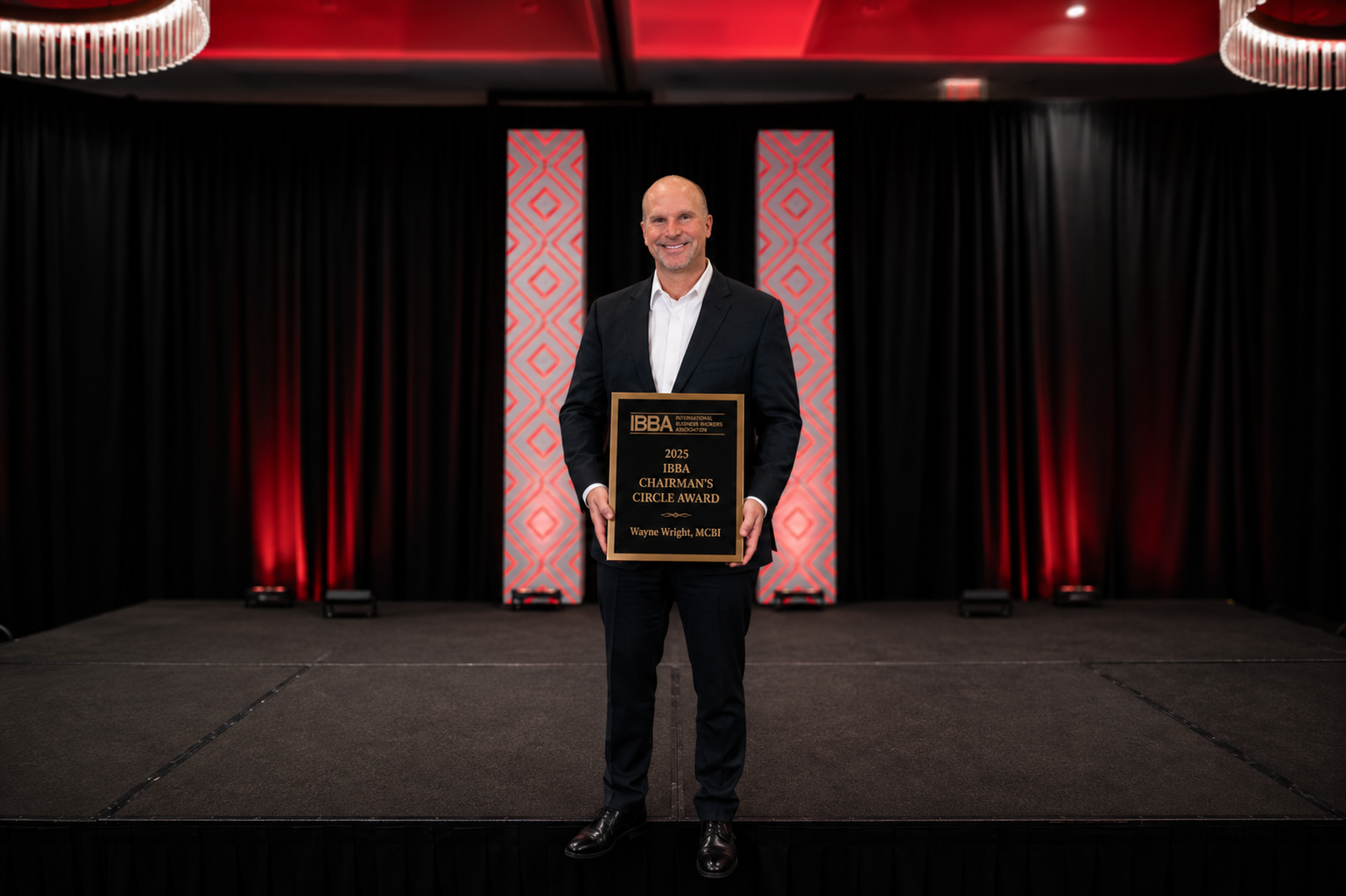 Wayne Wright receiving recognition as an IBBA Chairman's Circle Award recipient for outstanding business brokerage performance in 2025.