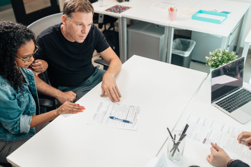 Business owner meeting with an M&A advisor before selling a business.